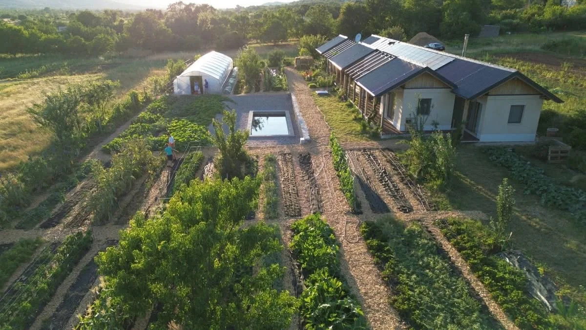 Farm from above with solar panel roof at golden hour